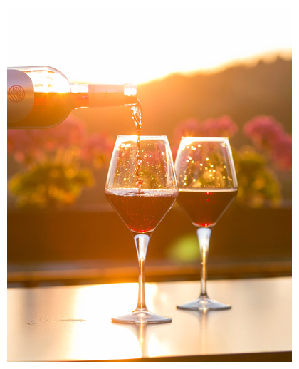 Two glasses of wine being poured at winery